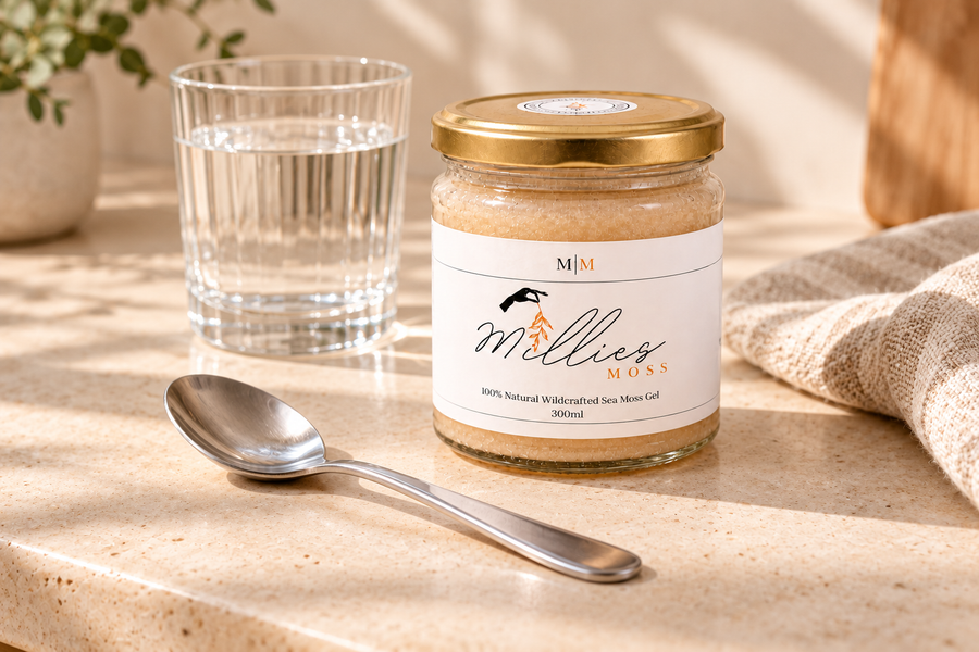 A closed Millie’s Moss Golden Gel jar beside an empty teaspoon and a glass of water.