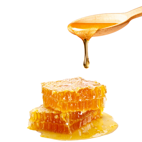 Wooden spoon drizzling honey onto a stack of honeycomb on a white background