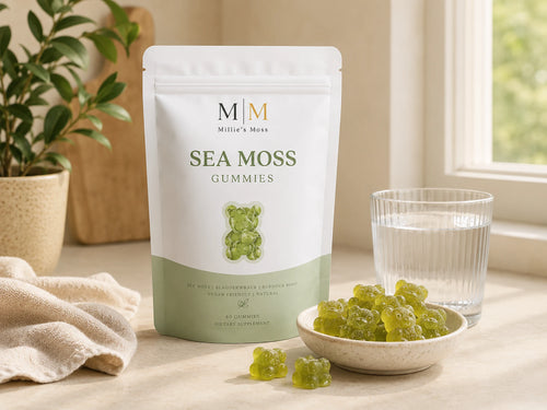 Millie’s Moss Apple Sea Moss Gummies pouch with green gummies and a glass of water on a kitchen counter.