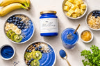 Flat lay of blue sea moss smoothie bowls and smoothie with kiwi, banana, blueberries and granola