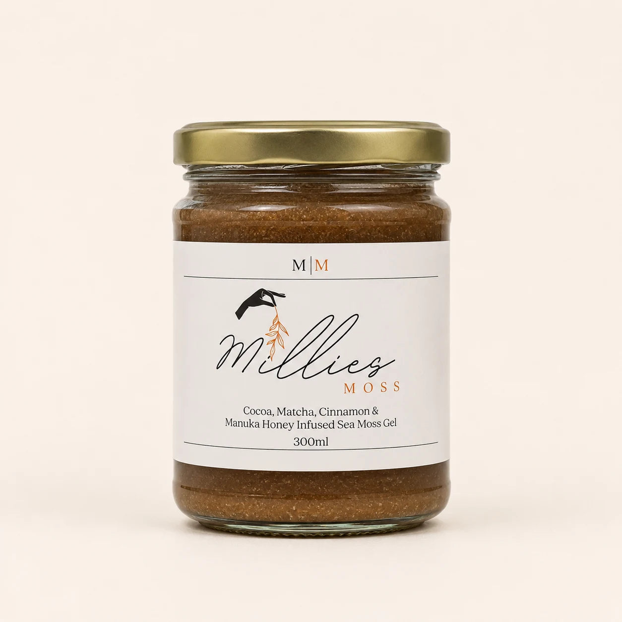 Millie’s Moss Cocoa, Matcha, Cinnamon & Manuka Honey Infused Sea Moss Gel 300ml jar on a warm off-white background.