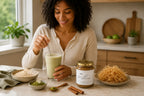 Millie’s Moss Cocoa, Matcha and Cinnamon sea moss gel jar with a mug, matcha, cinnamon and raw sea moss on a kitchen counter.