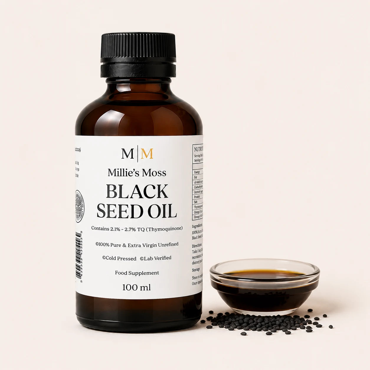 Millie's Moss High Strength Black Seed Oil 100ml bottle beside a glass dish of black seed oil with whole black seeds on an off-white background.