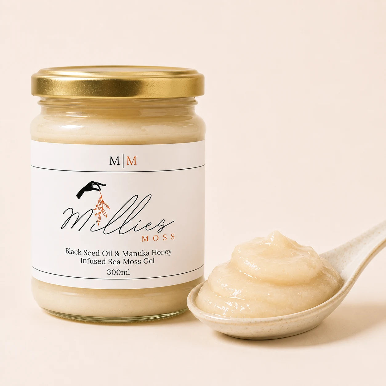 Millie's Moss Black Seed Oil & Manuka Honey Infused Sea Moss Gel showing the gel's smooth thick texture beside the jar