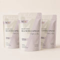 Three-pack bundle of Millie's Moss Purple Sea Moss Capsules on a warm off-white background.