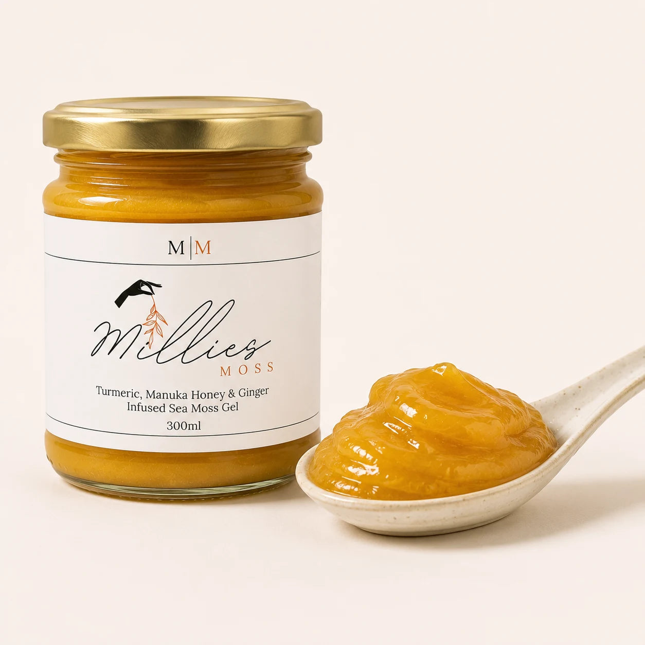 Millie's Moss Turmeric, Manuka Honey & Ginger Infused Sea Moss Gel showing the gel's smooth thick texture beside the jar