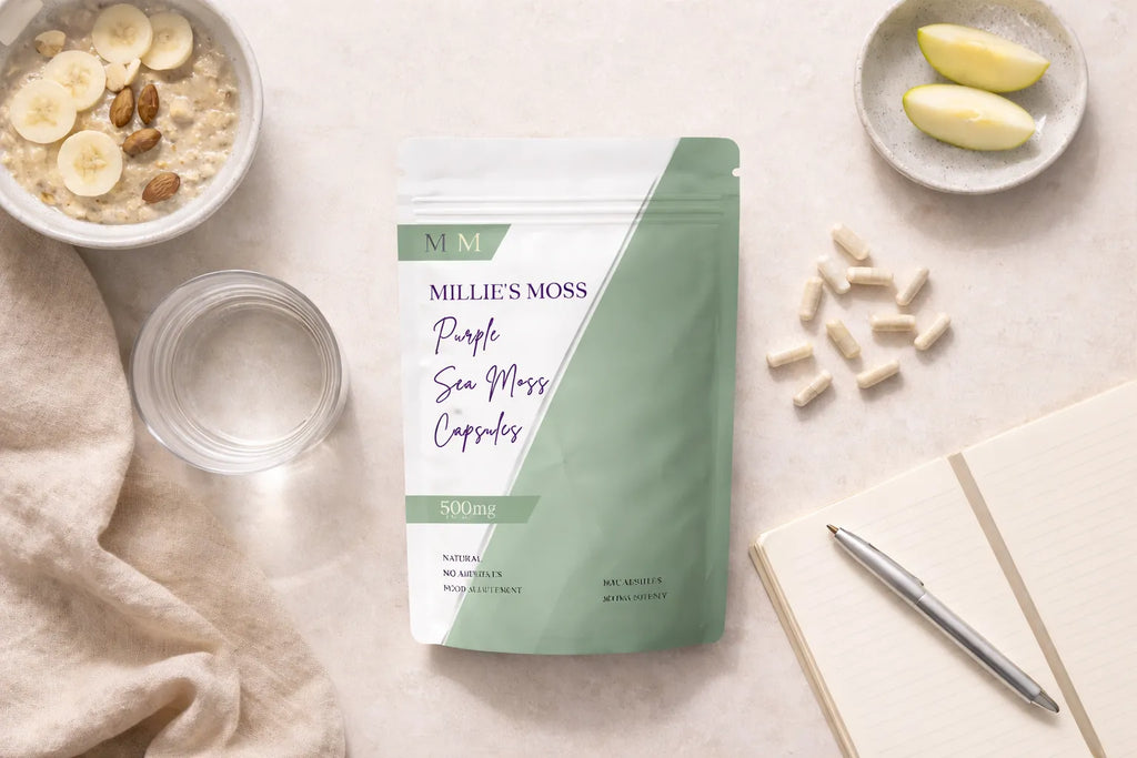 Flat lay of purple sea moss capsules with breakfast bowl, apple slices, and notebook for a daily wellness routine.