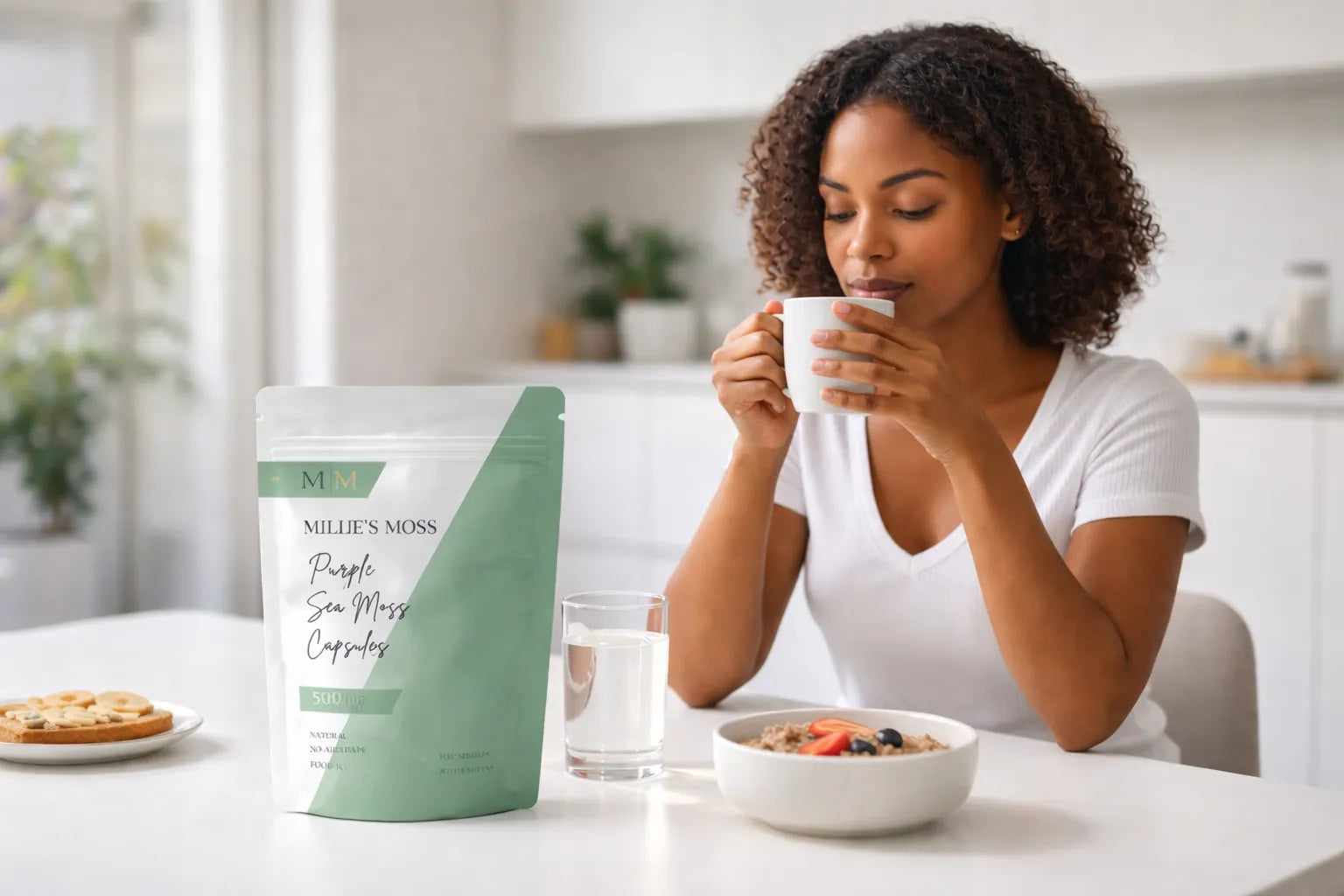 Woman enjoying tea during a morning wellness routine with Millie’s Moss purple sea moss capsules on the table.