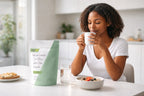 Woman enjoying tea during a morning wellness routine with Millie’s Moss sea moss and aloe vera capsules on the table.