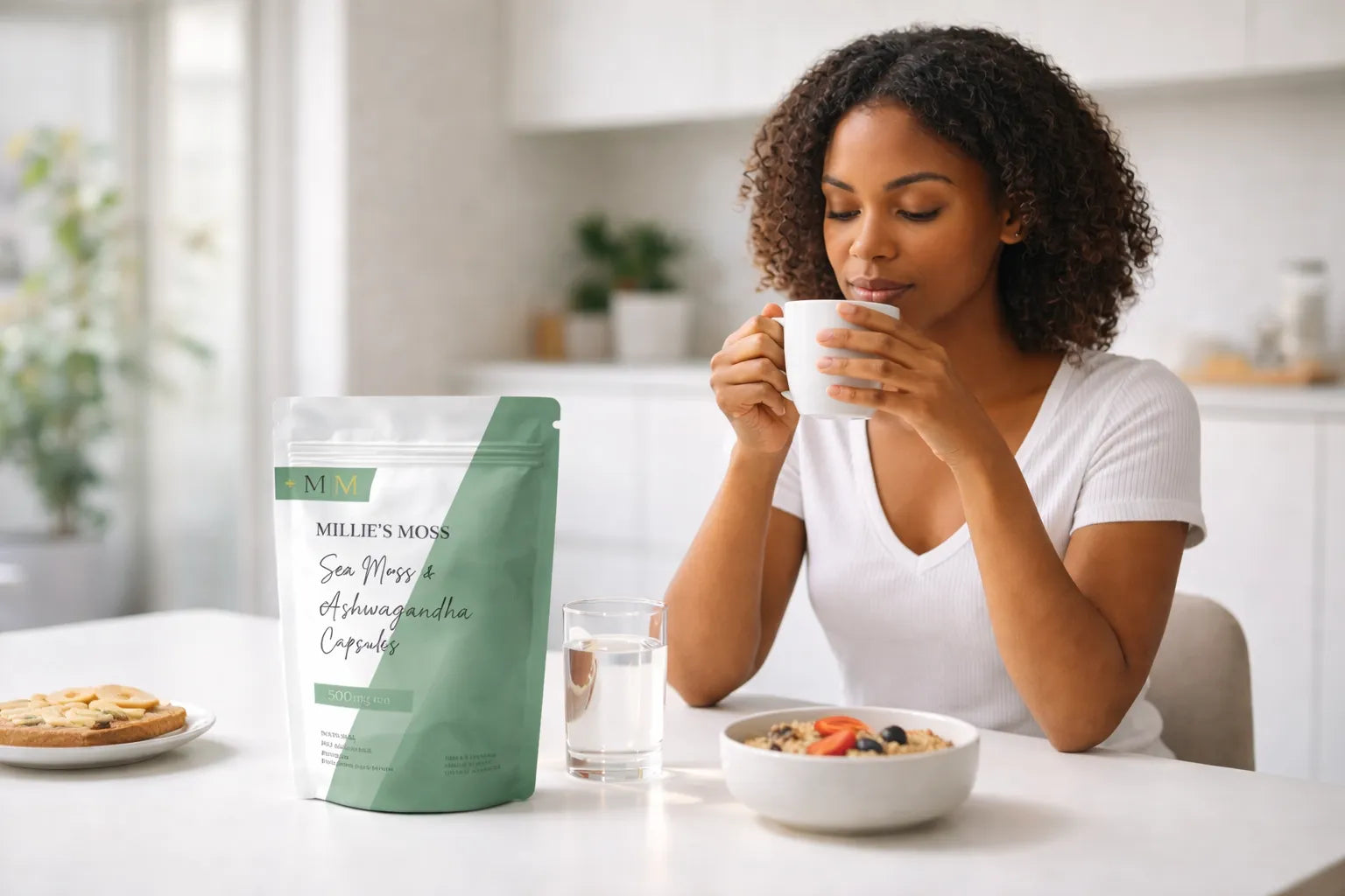 Woman enjoying tea during a morning wellness routine with Millie’s Moss sea moss and ashwagandha capsules on the table.