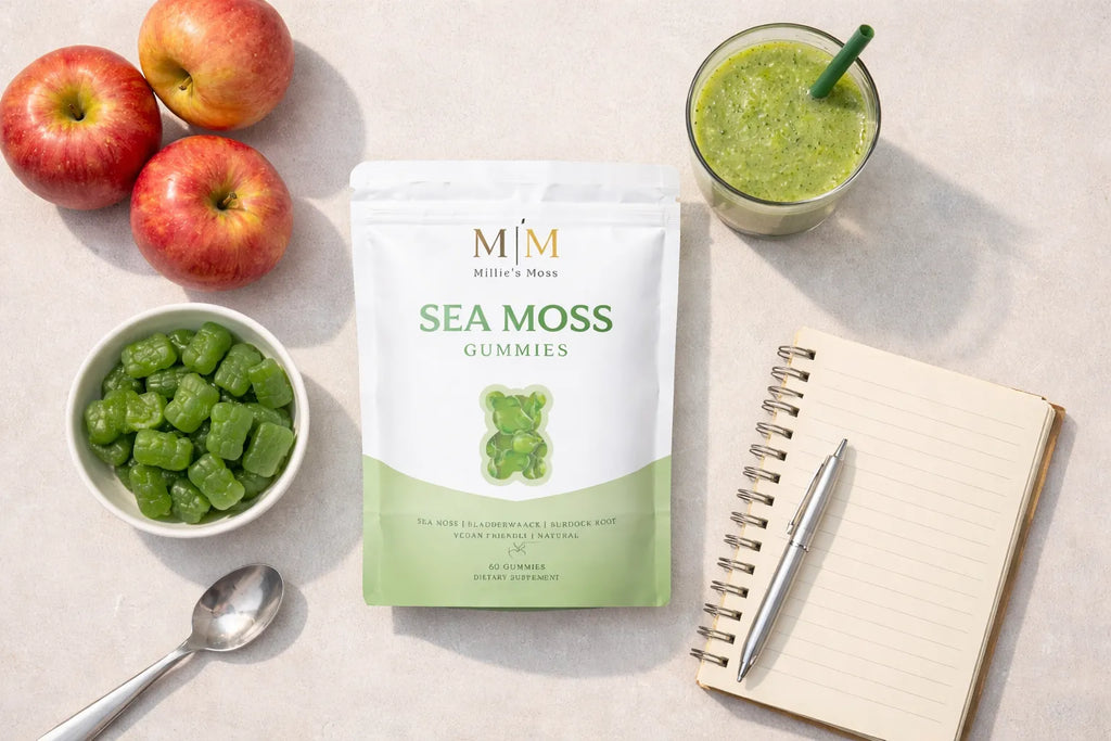 Flat lay of sea moss gummies supplement pouch with apples smoothie bowl of gummies and notebook for daily wellness routine