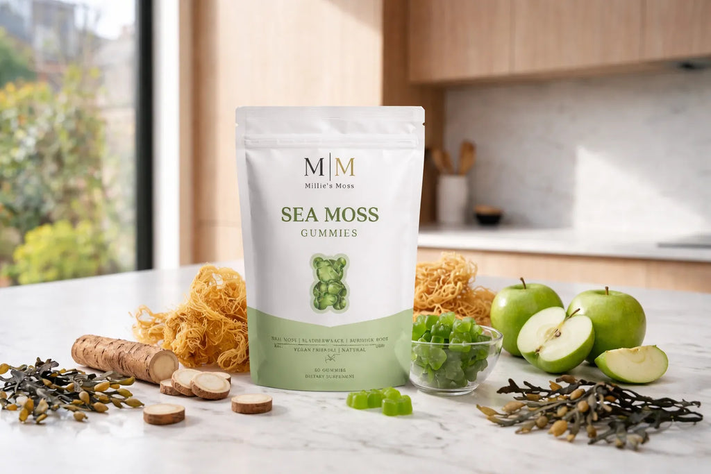 Sea moss gummies supplement pouch surrounded by green apples sea moss bladderwrack and burdock root ingredients